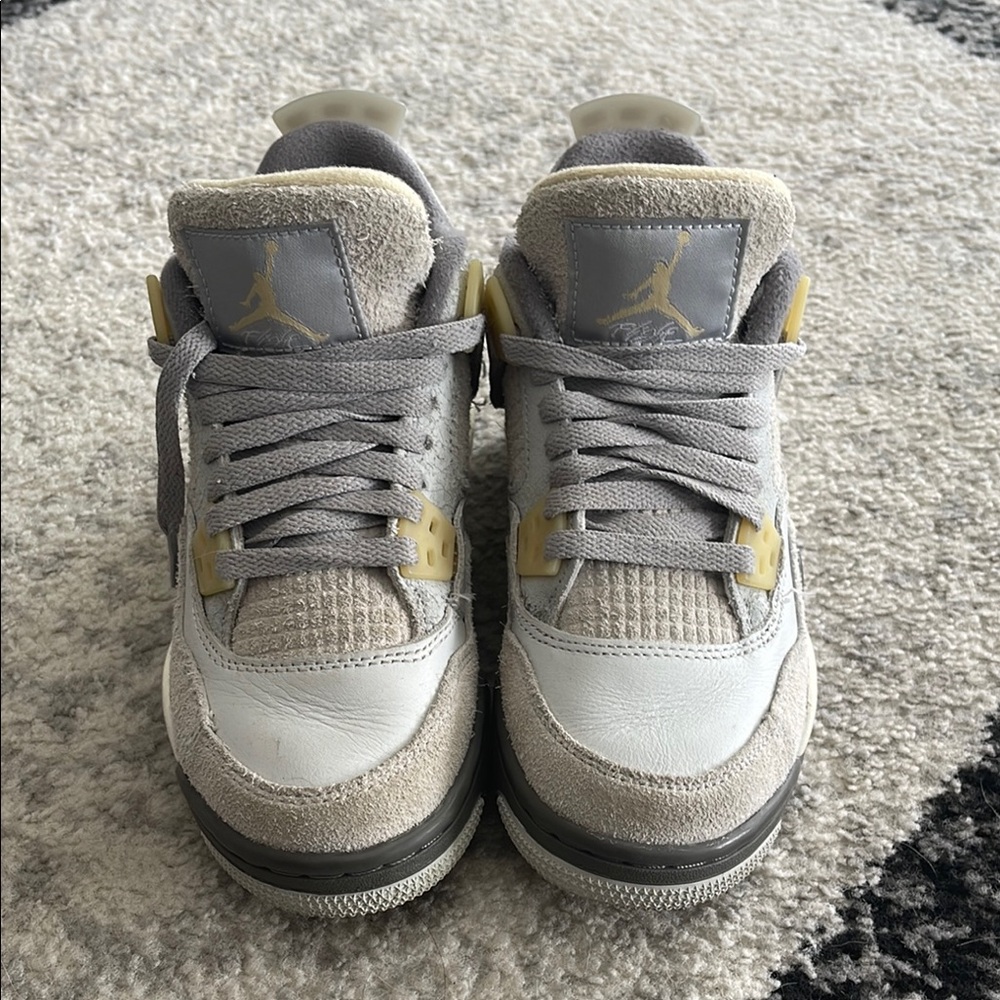 Air Jordan 4 Retro Grey and White Sneakers.